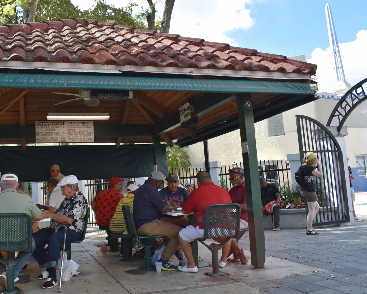 Players at the tables of Domino Park on Calle Ocho in Little Havana, free to watch on a day before a Bahamas cruise from Miami
