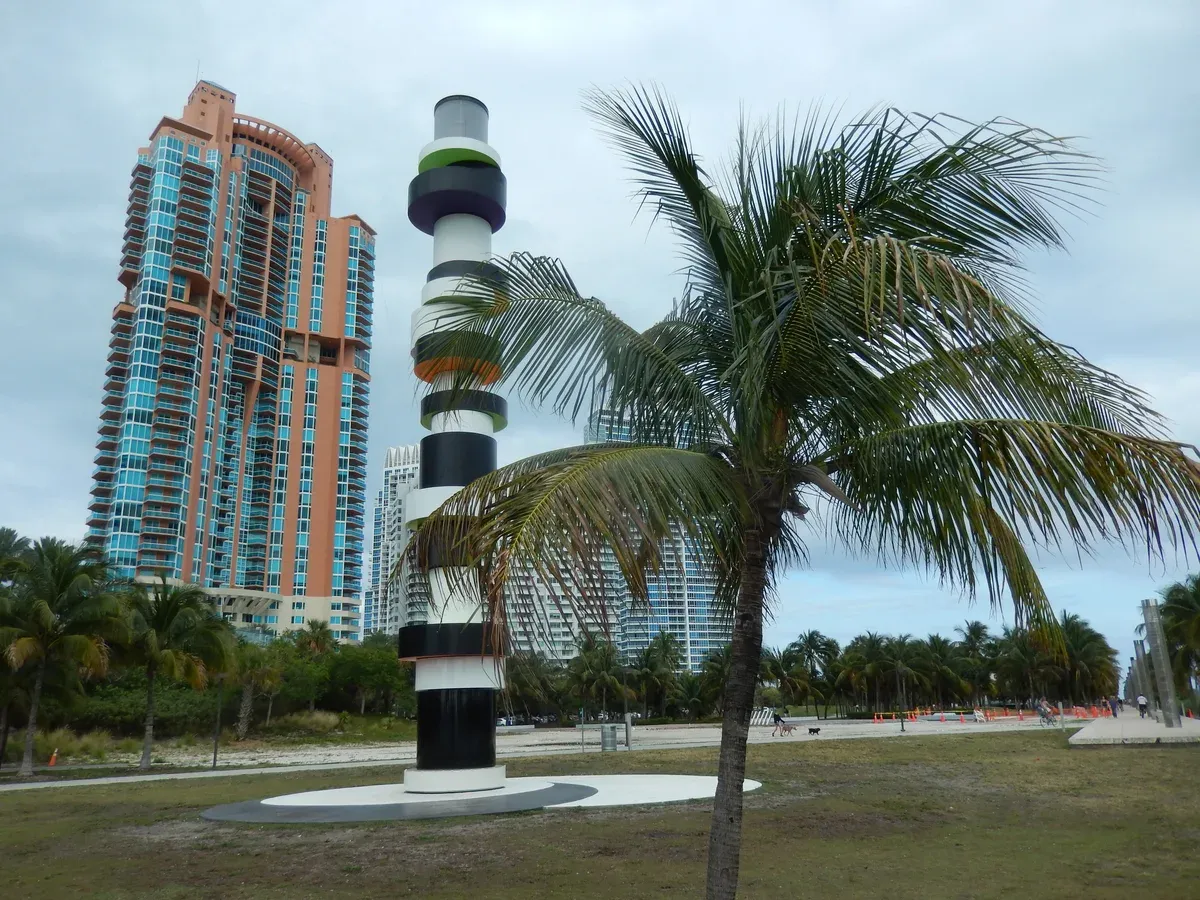 The lighthouse sculpture and palms in South Pointe Park, a free stop at the mouth of Government Cut before a Bahamas cruise from Miami