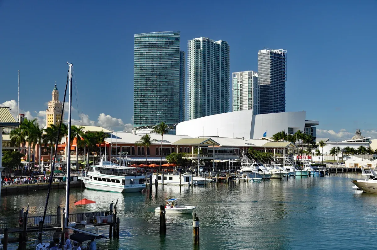 Boats in the Bayside Marketplace marina with downtown towers behind, the start of a Biscayne Bay boat tour Miami