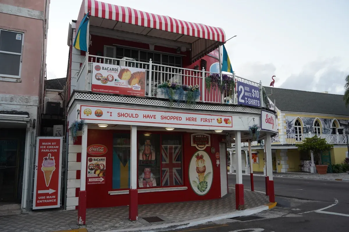 Red and white shopfront on Bay Street, downtown Nassau, passed on a Nassau trolley tour