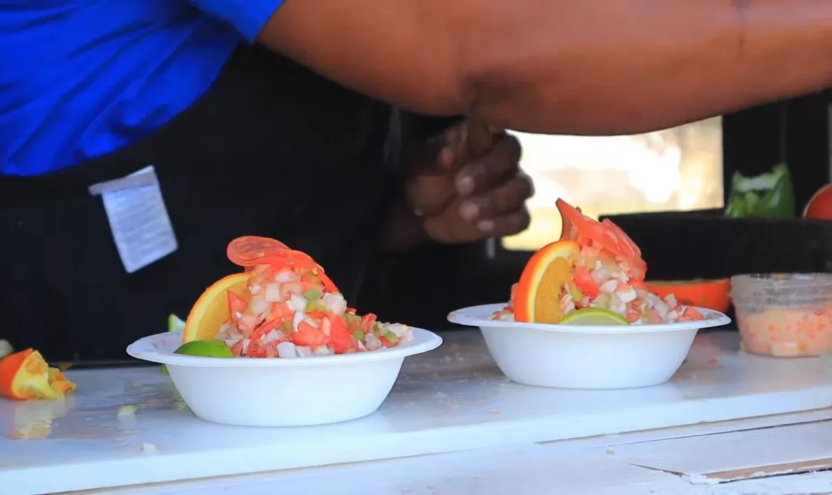 Fresh conch salad being prepared at a Bahamian stall, a staple of a Nassau food tour